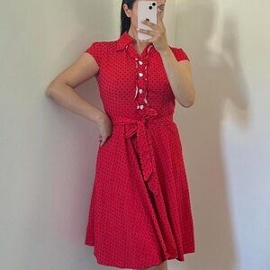 Retro style red polka dot dress with cap sleeves and heart-shaped white buttons